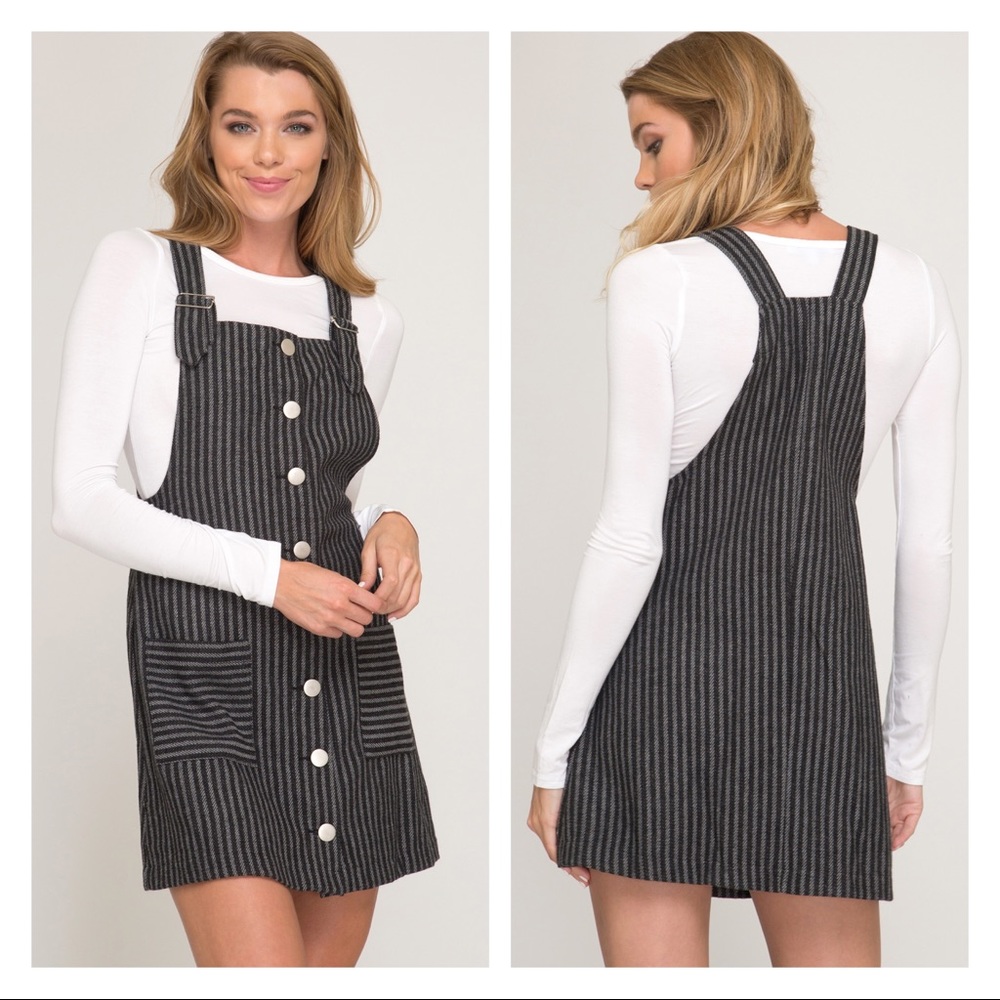Black color mini skirt overall. Adjustable strap